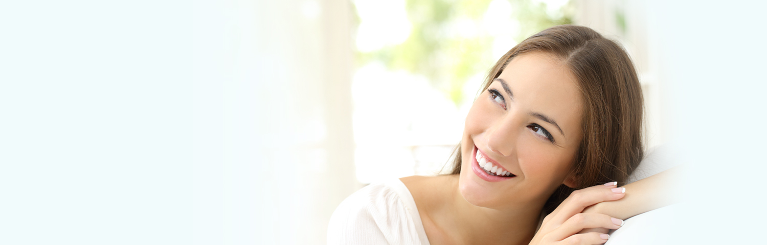 Happy woman smiling after Teeth Whitening