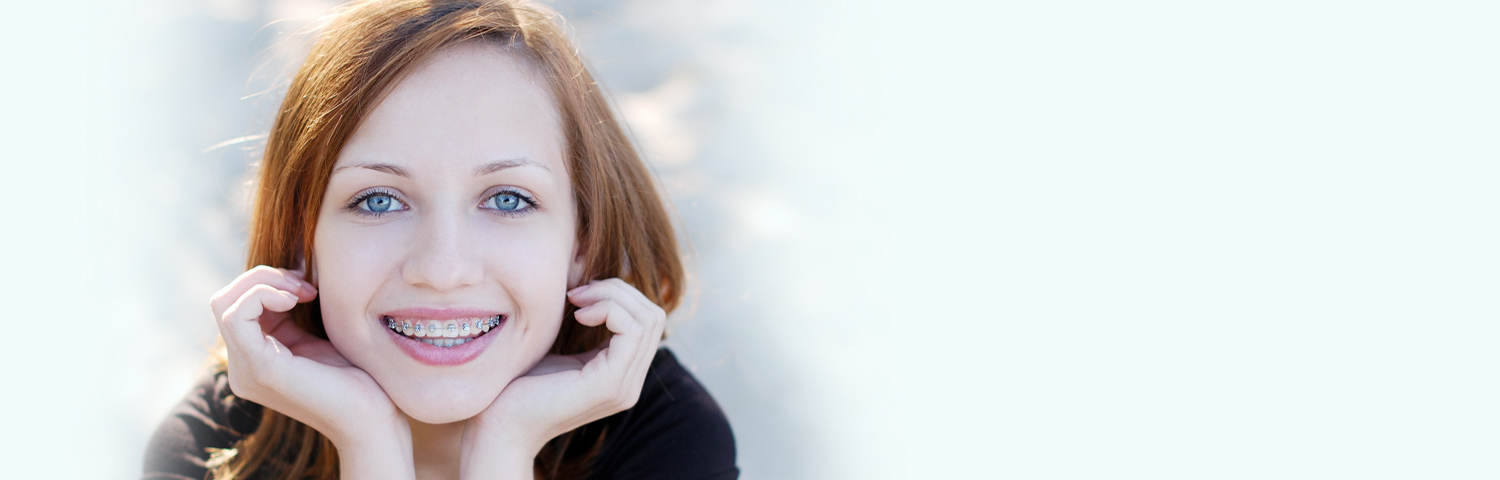 Young girl smiling with orthodontic braces